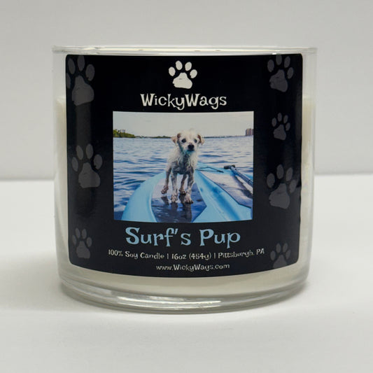 WickyWags candle labeled 'Surf's Pup' with a dog on a leash in water